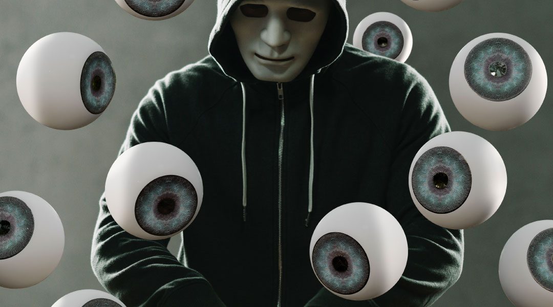 Masked man shopping online with eyeballs watching
