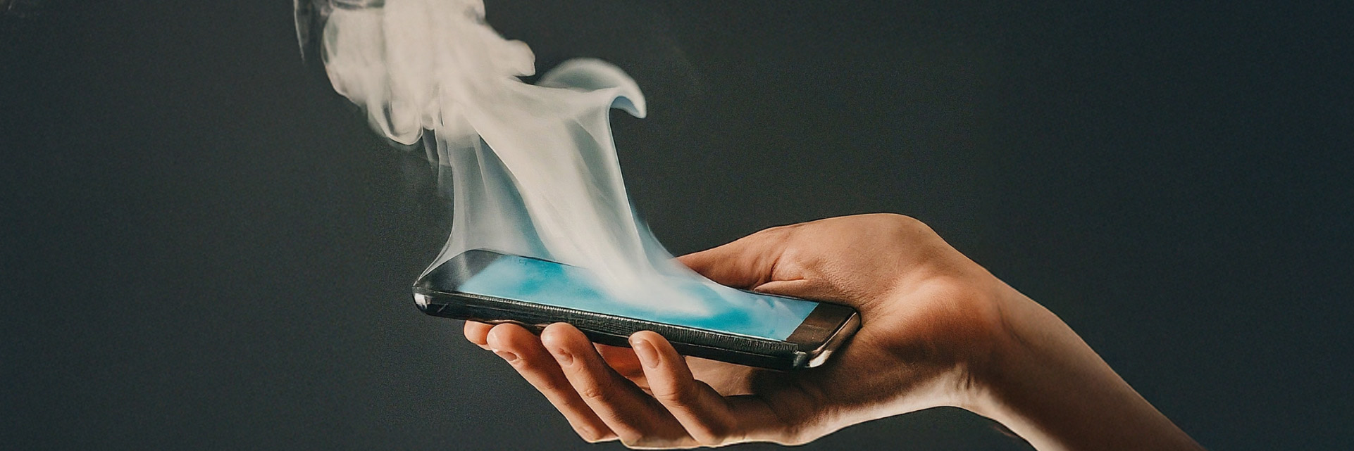 A phone with smoke coming from it - headline banner for good practises with phone chargers and cables